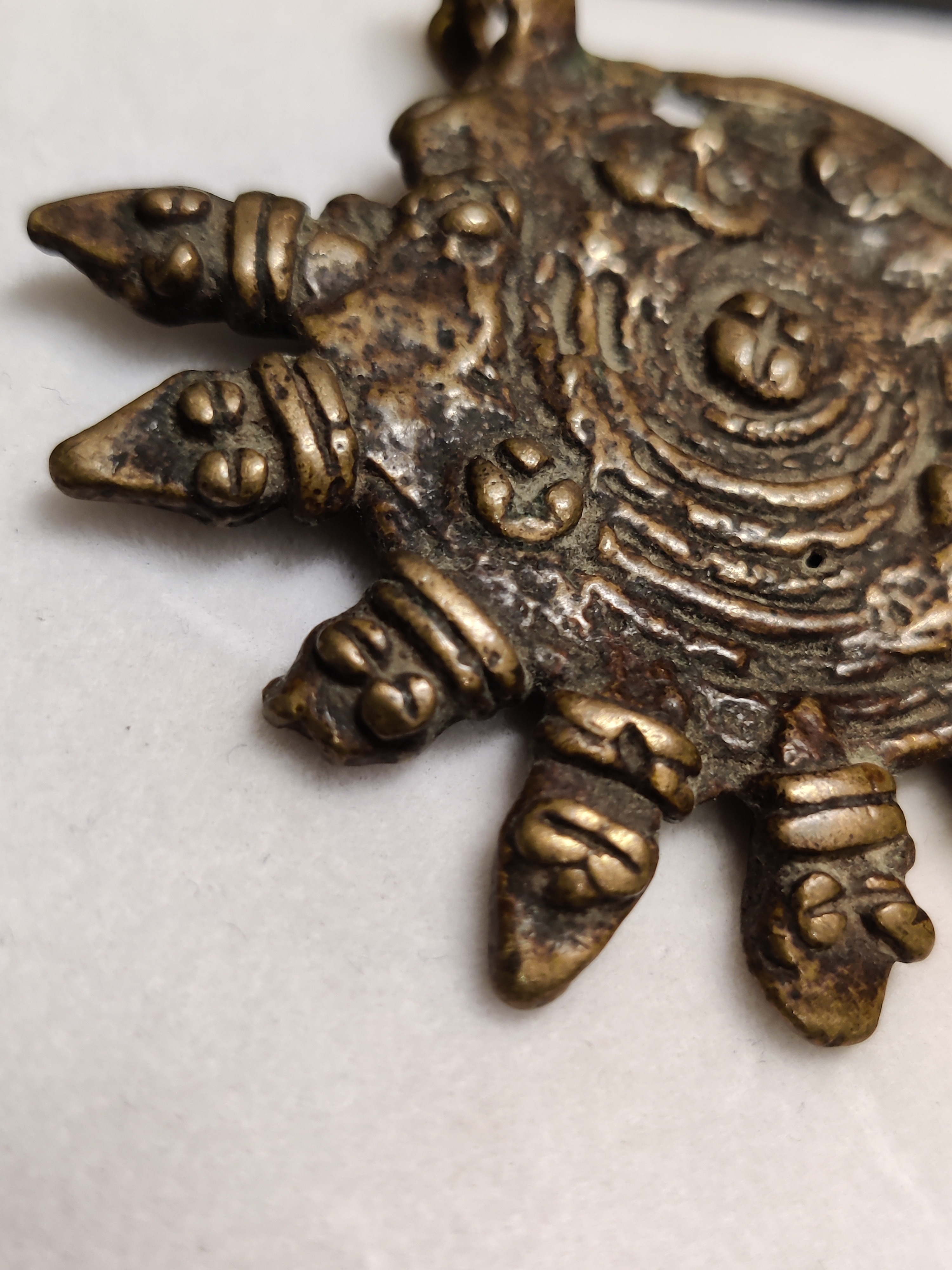 Bronze of sun with snake heads