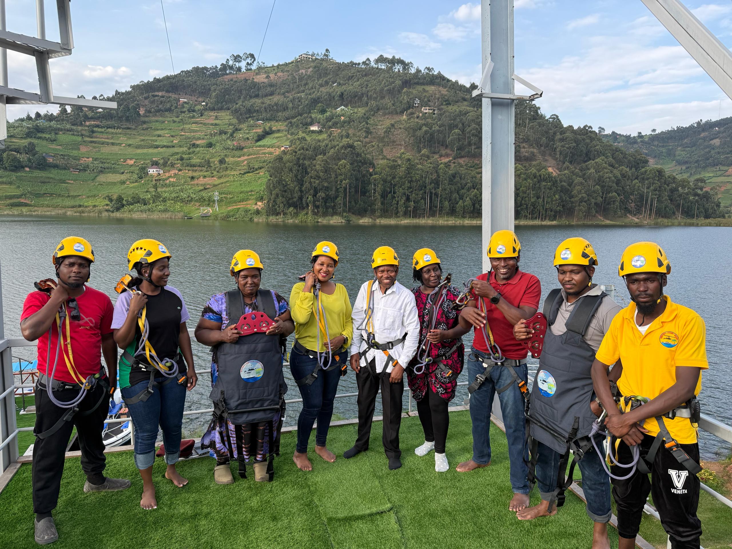 Tourists getting ready with safety gear for the zipline experience at Bunyonyi Luxury Resort.