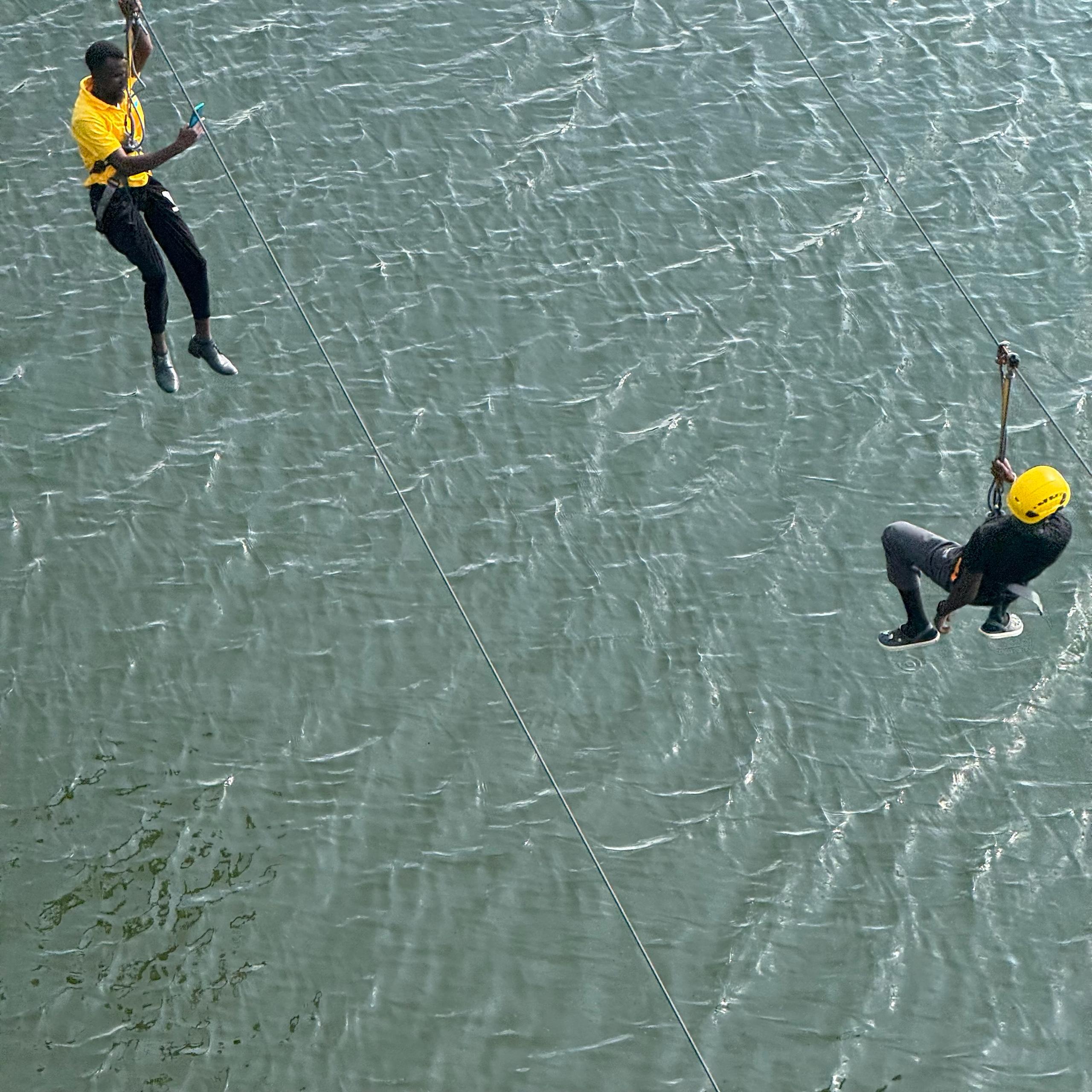 Guests enjoying a thrilling zipline ride across Lake Bunyonyi at Bunyonyi Luxury Resort.