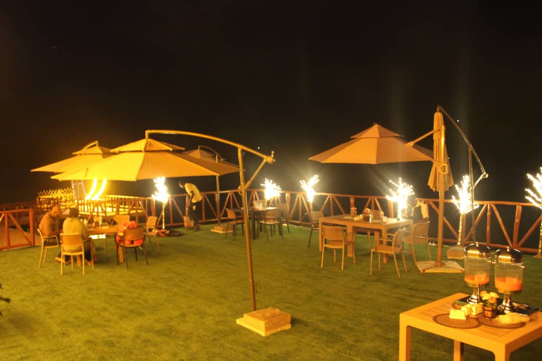 Evening view of the illuminated luxury dock at Bunyonyi Luxury Resort on Lake Bunyonyi, Uganda.