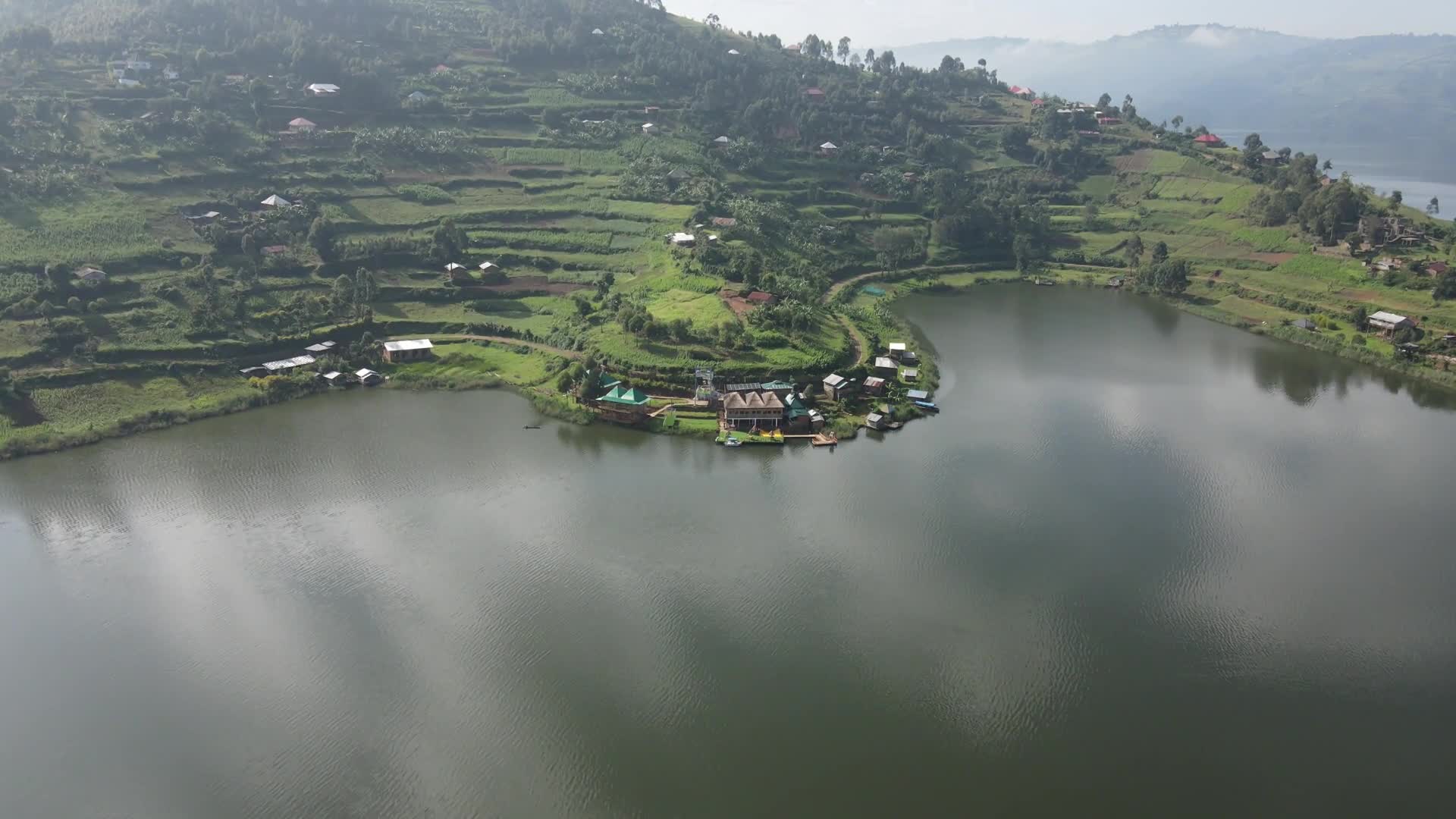 Stunning drone footage capturing the panoramic beauty of Lake Bunyonyi and the Bunyonyi Luxury Resort from above, showcasing the serene waters and lush surroundings.