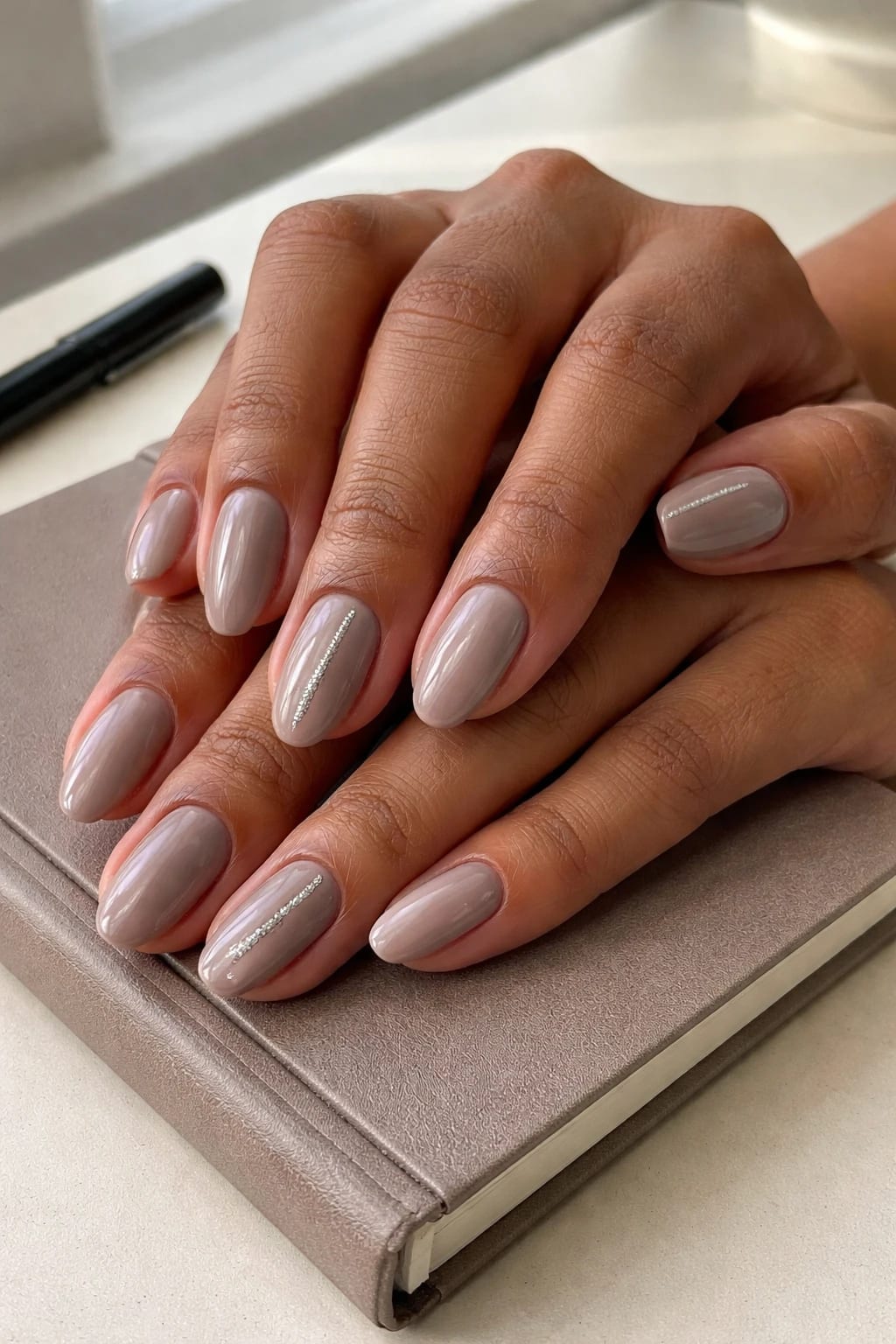 Neutral Almond Work Nails with a Single Glitter Stripe