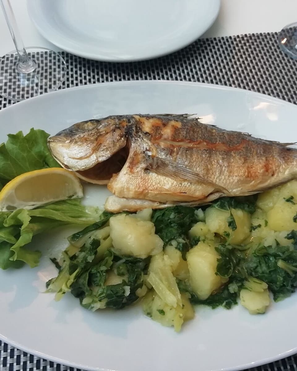 Grilled fish with seasonal greens
