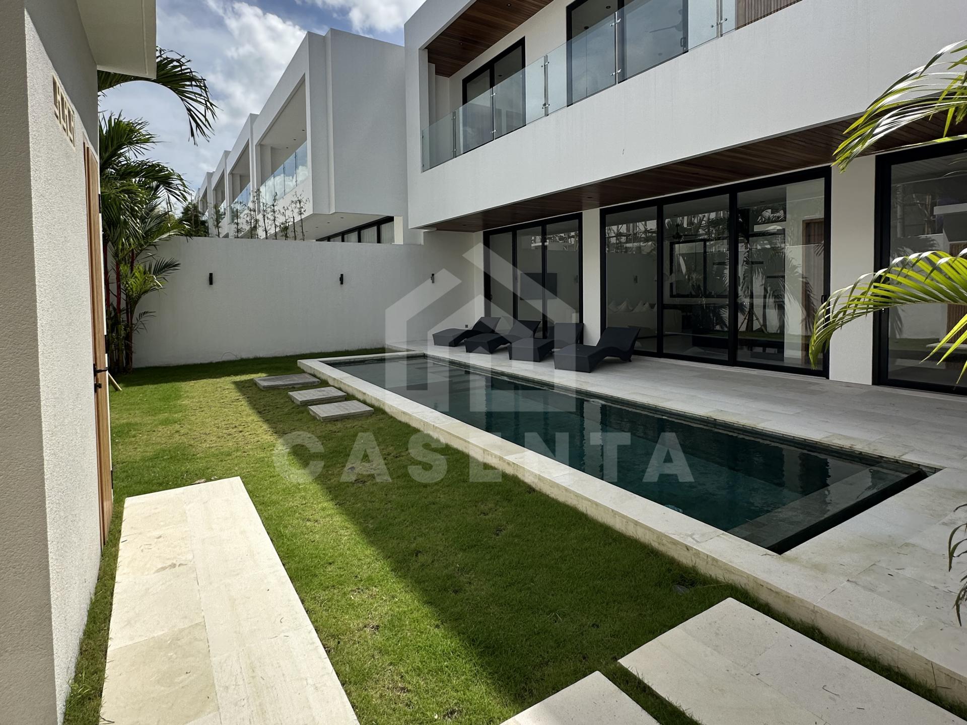 Private swimming pool and landscaped garden at a modern Tumbak Bayuh villa