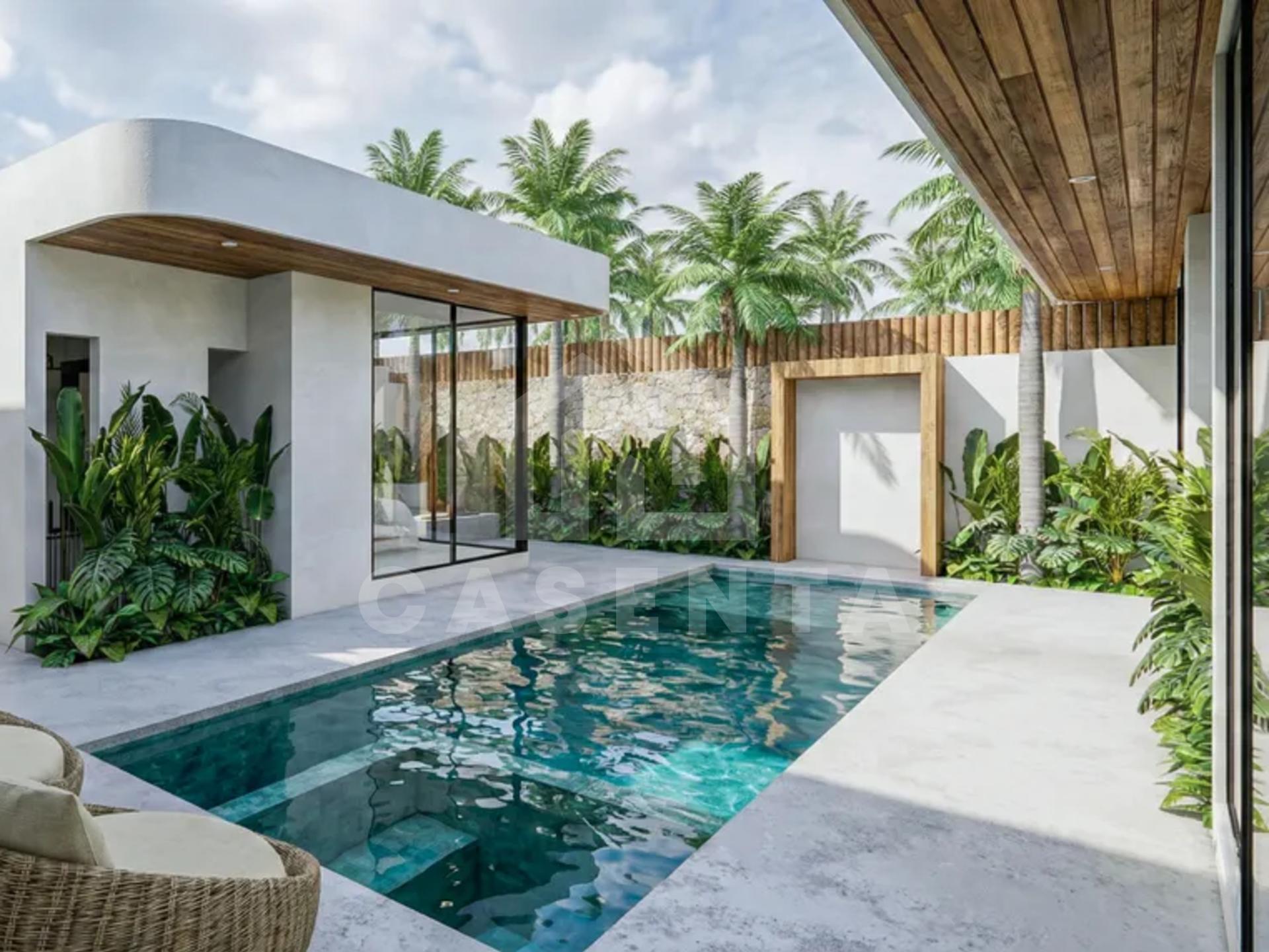 Bali villa outdoor living area with private pool, lounge chairs and built-in barbecue.