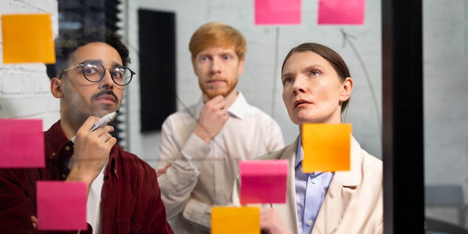 colleagues-looking-at-post-its-medium-shot.jpg