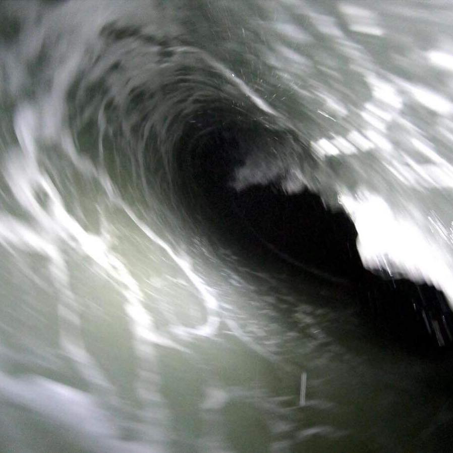 surfer in the tube at mundaka by night with a light