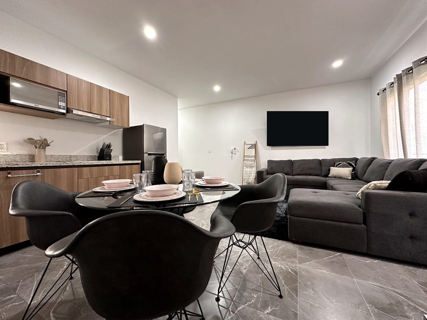 Open living and dining room with kitchen and sectional sofa