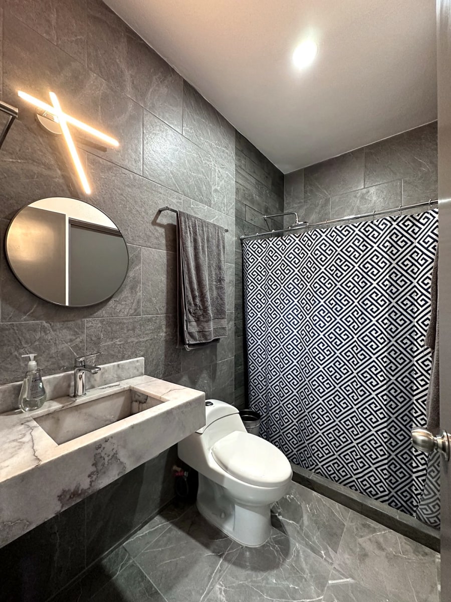 Bathroom with marble sink and walk-in shower