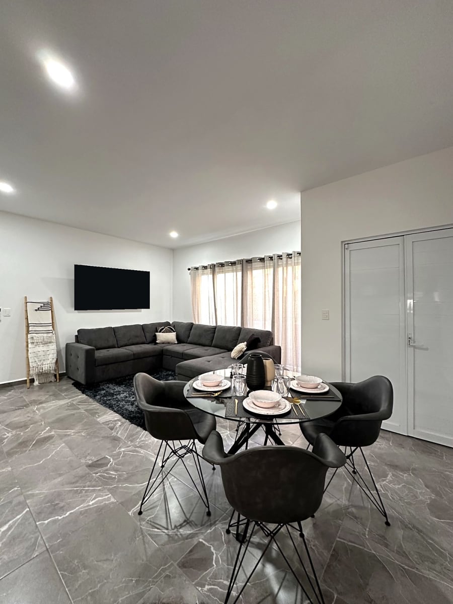 Sectional sofa beside linen-curtained windows