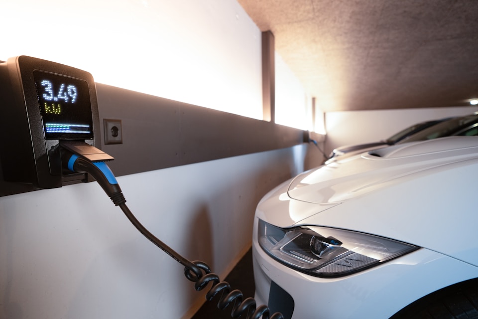 Technician installing a modern EV charging station.