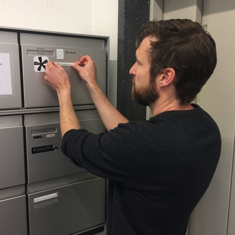 Lionel Hertig putting the Ren Systems sticker onto our first mailbox in Switzerland