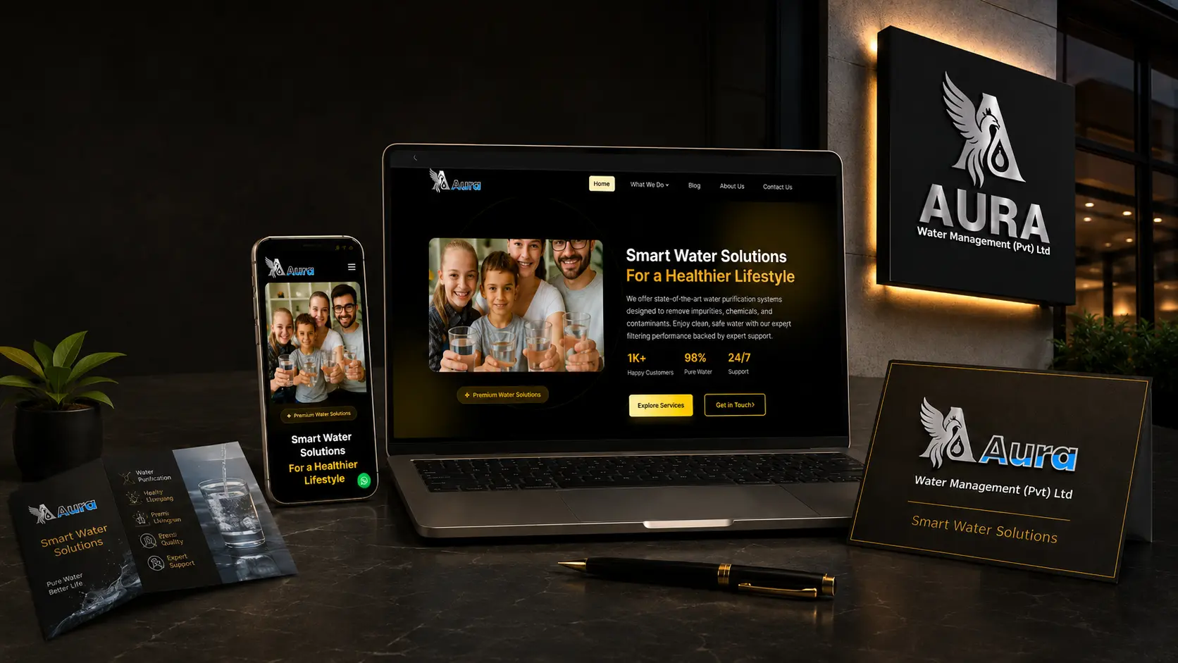 Aura Water Management branding mockup featuring a responsive water purification website on laptop and mobile, illuminated signboard, logo design, and promotional materials.