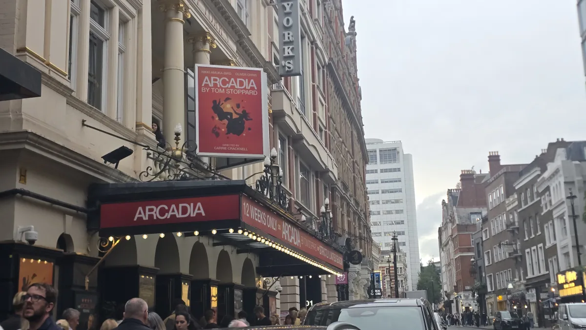 The Duke of York's Theatre frontage on an evening street, a lit marquee reading Arcadia with a poster for Tom Stoppard's play and a sign for its 12-week run.