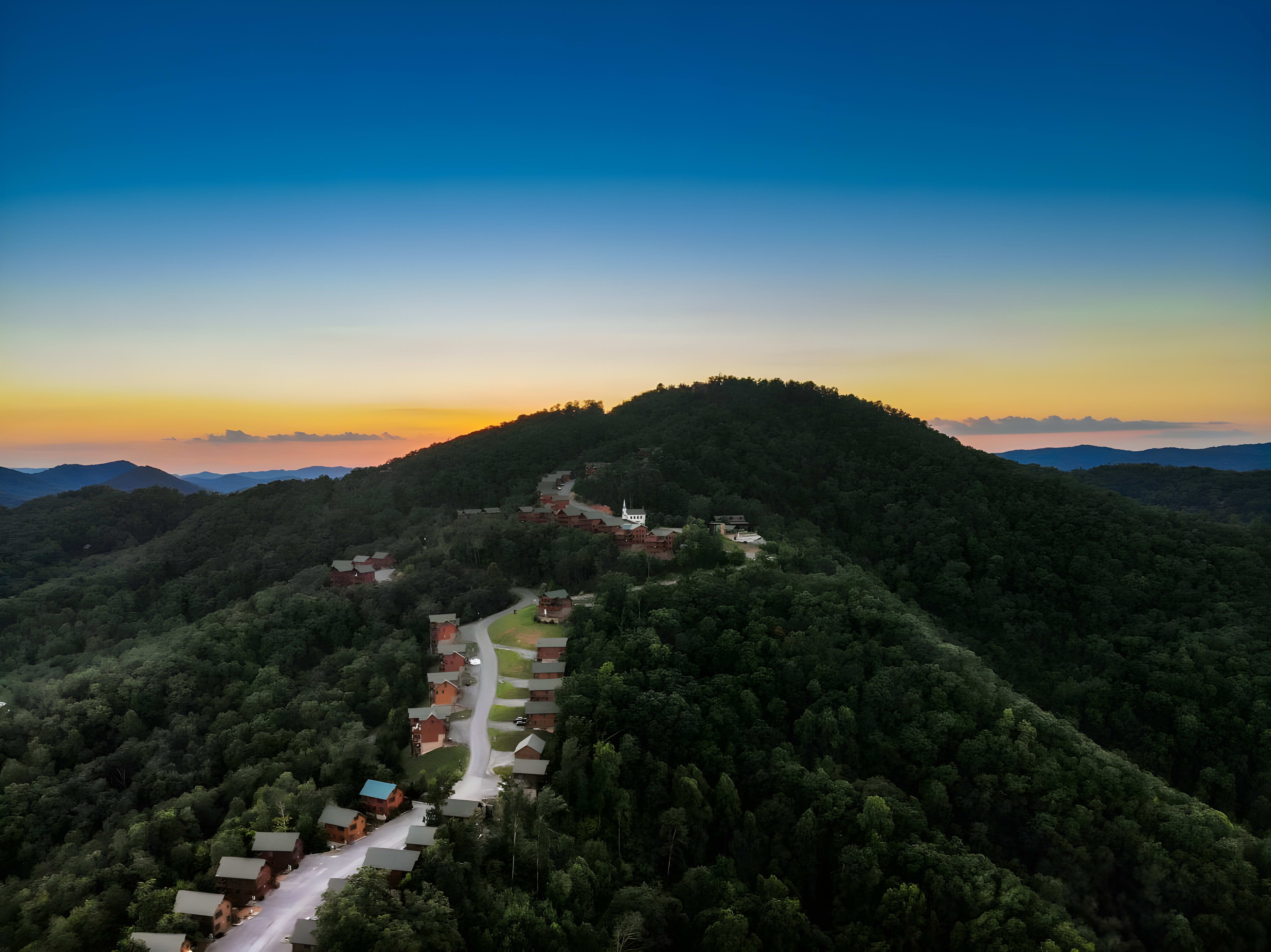 Aerial view of a Smoky Mountain cabin resort community at sunset