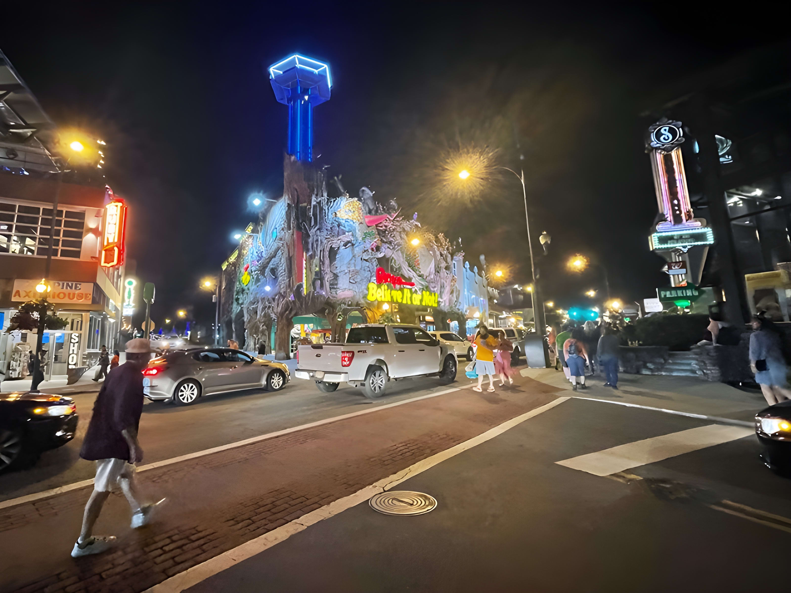 Downtown Gatlinburg, Tennessee lit up at night with the Smoky Mountains in the background