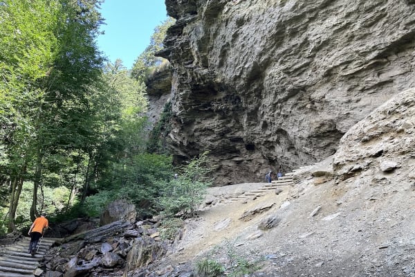 Hikers resting under the massive Alum Cave bluff