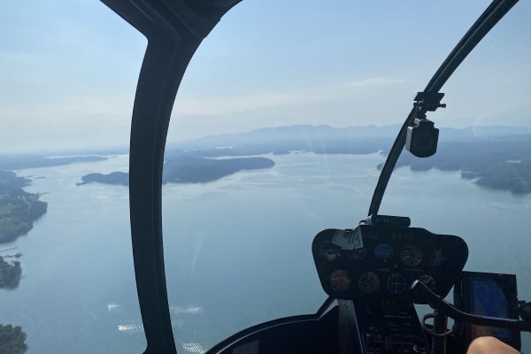 Helicopter flying over mountain landscape