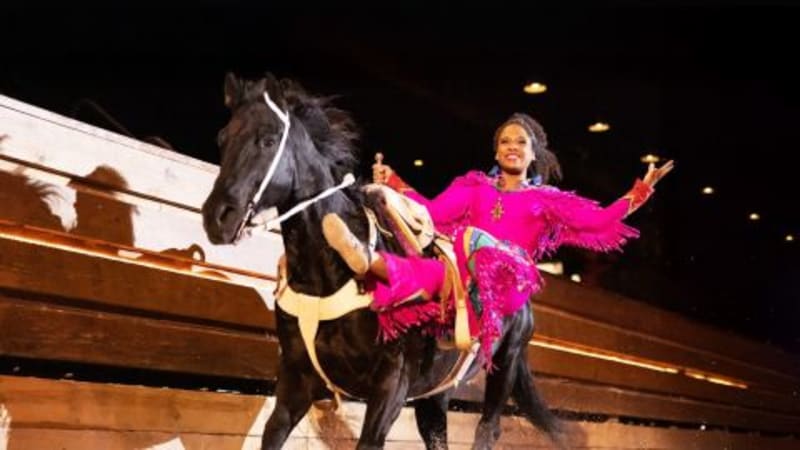 Horses and riders performing in Dolly Parton's Stampede arena