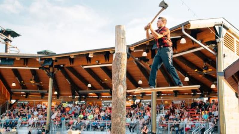 Lumberjacks competing in the log roll at Paula Deen's Lumberjack Feud