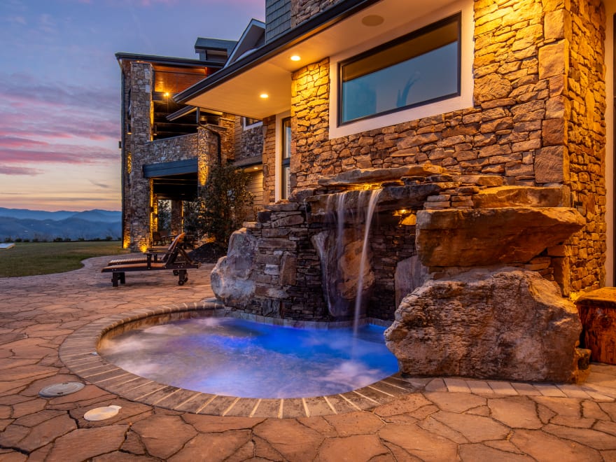 Luxury hot tub with mountain views at sunset