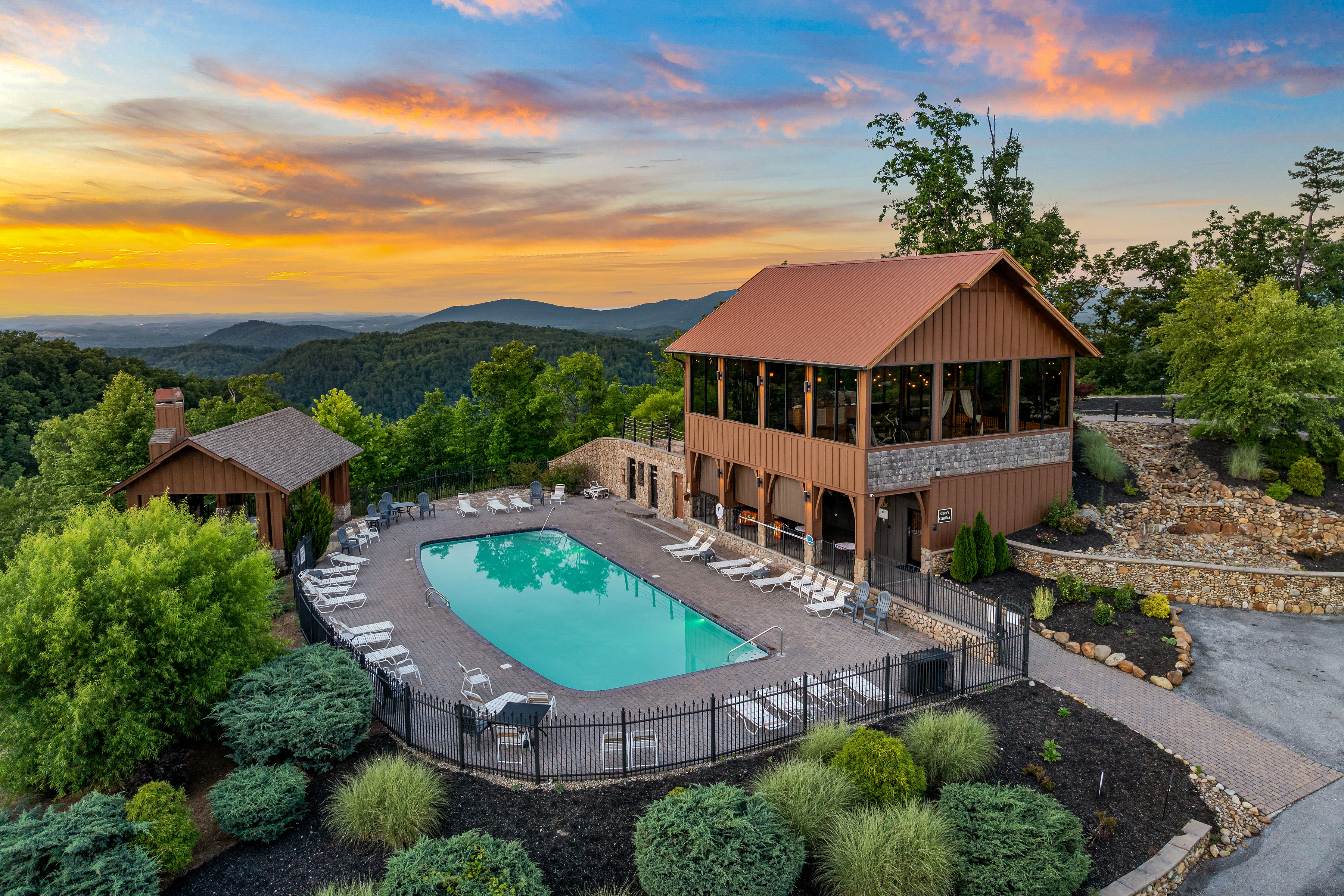 Resort pool and clubhouse at sunset with panoramic Smoky Mountain views