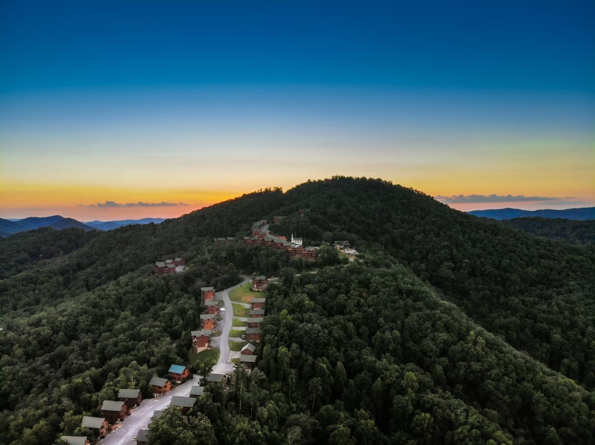 Aerial view of a Smoky Mountain cabin resort community at sunset