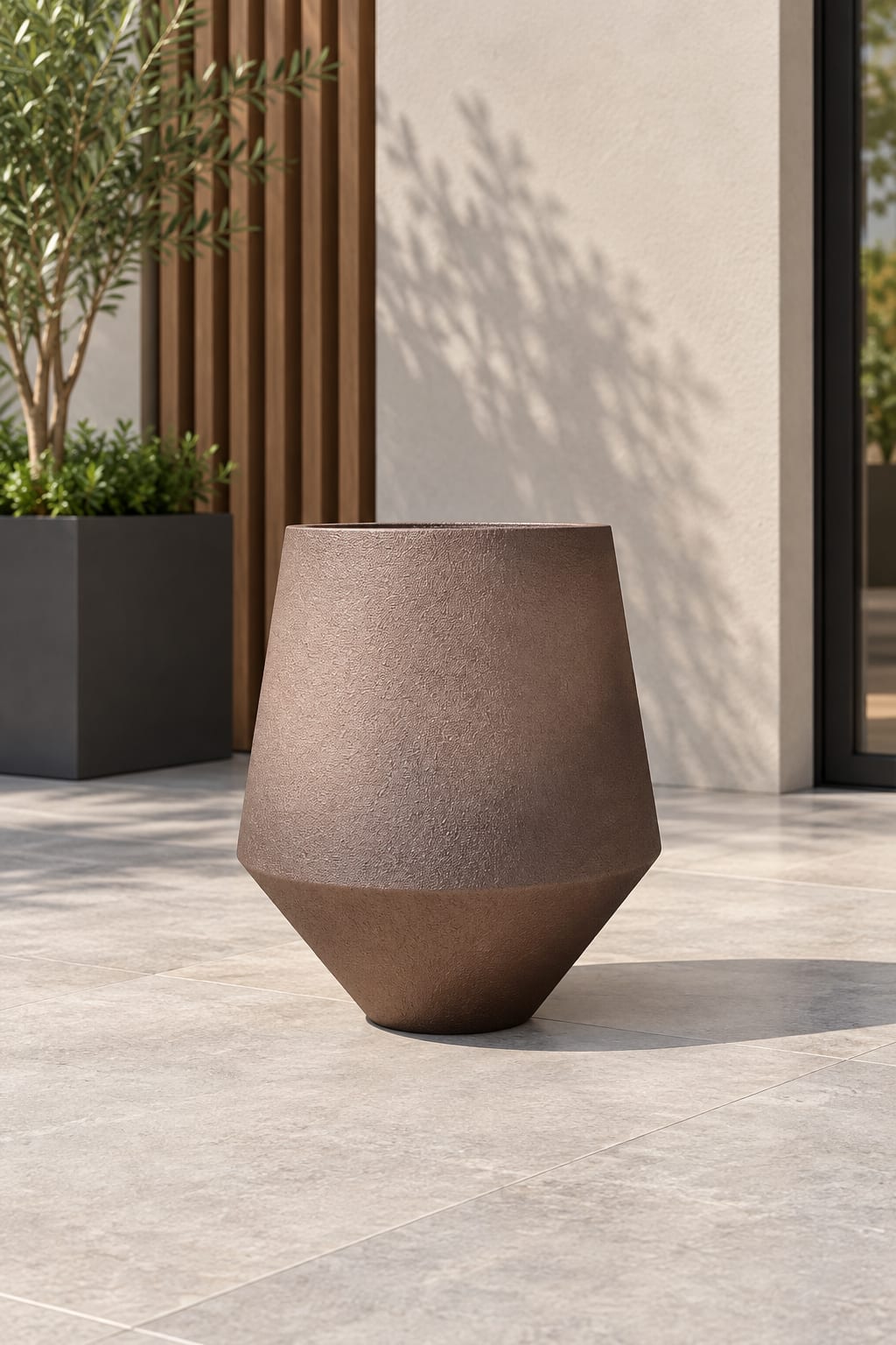 Forestry Geo brown angular planter showing its textured upper body and tapered base on an outdoor terrace