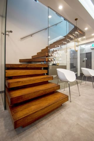 Family Dental Care · floating walnut — staircase or glass install by CAworks