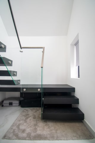 Cantilever · black steel treads — staircase or glass install by CAworks