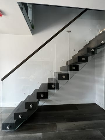 Frameless glass · dark treads — staircase or glass install by CAworks