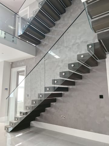 Floating · smoked oak on stone — staircase or glass install by CAworks