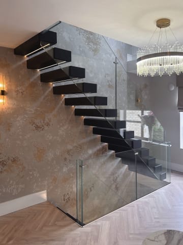 Floating · dark treads, stone — staircase or glass install by CAworks