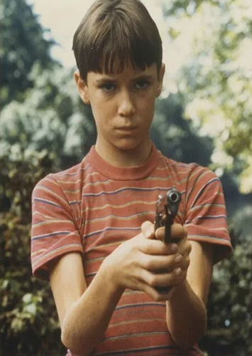image of Gordie Lachance looking at the camera while holding a gun