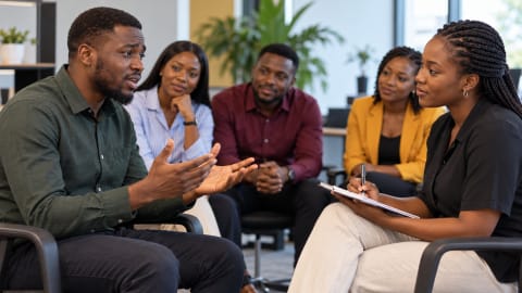 Colleagues practising a customer service conversation in a training session