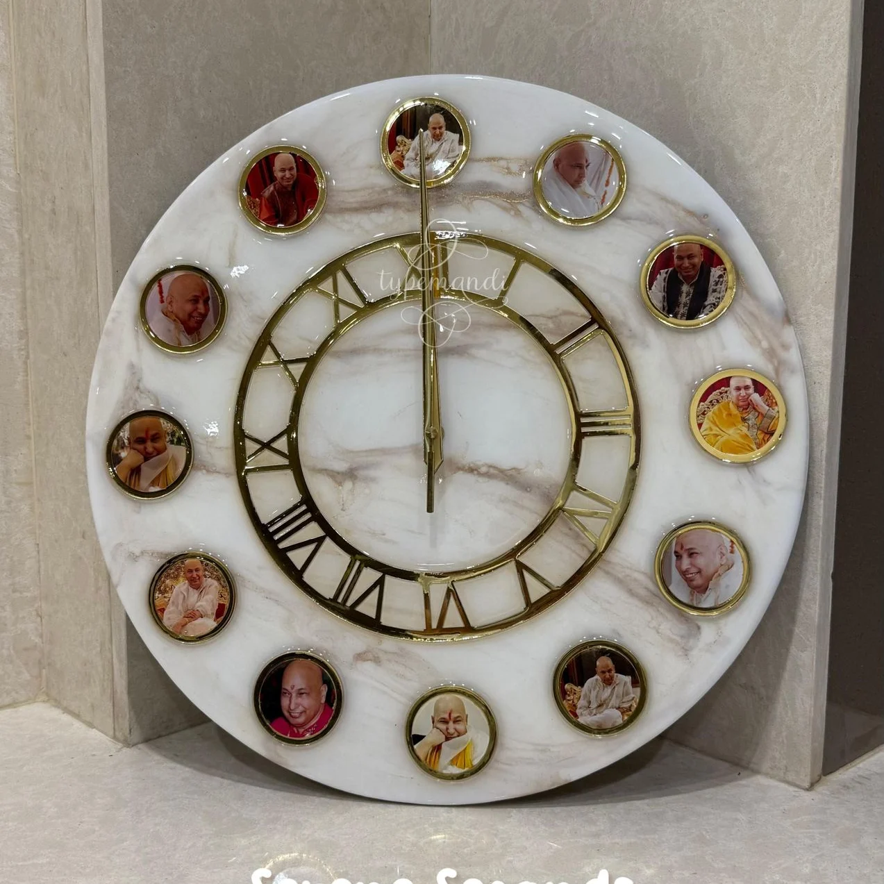 Guruji marble finish resin wall clock with 12 swaroops and gold roman numerals