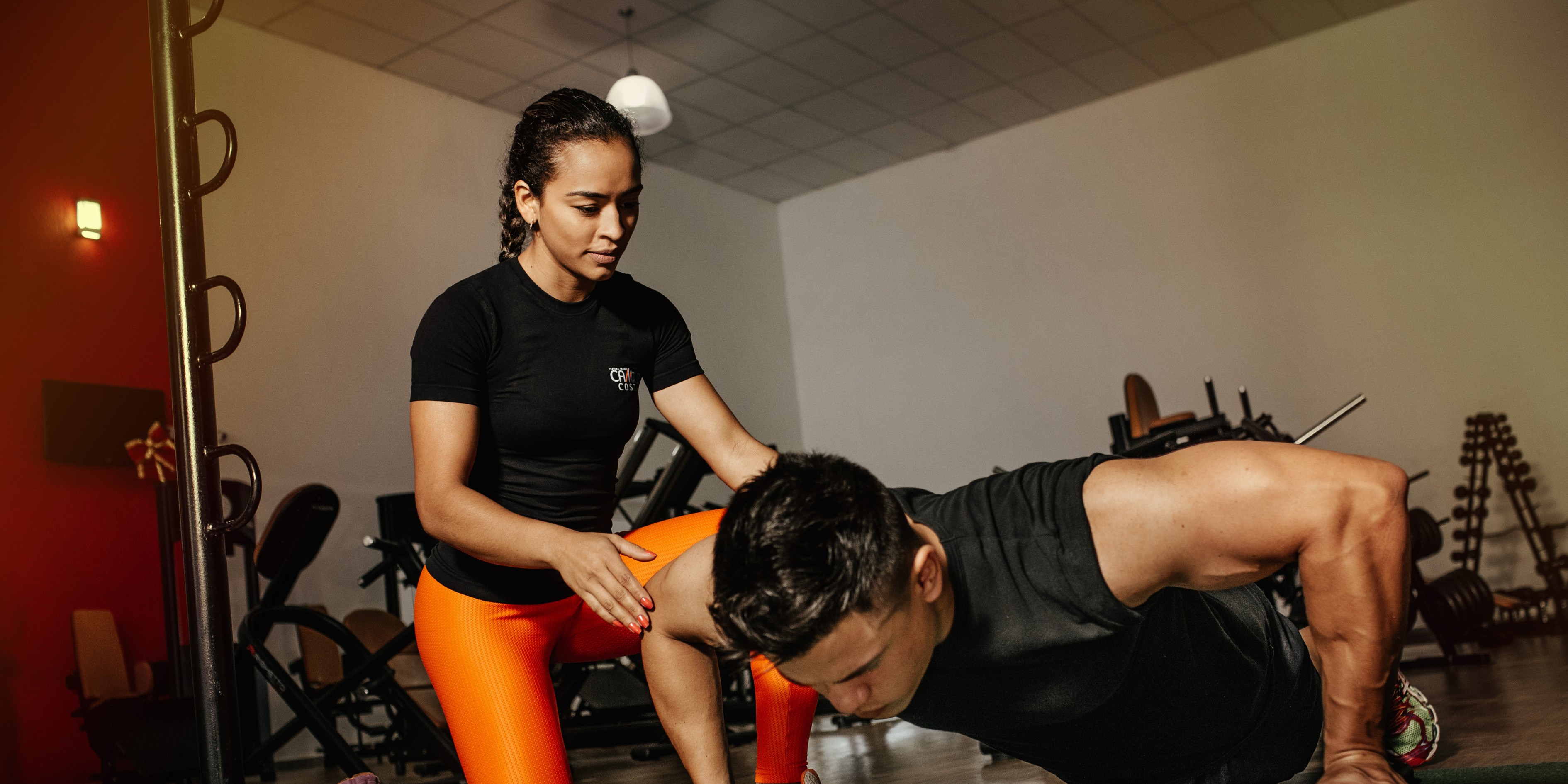 Personal trainer helping client