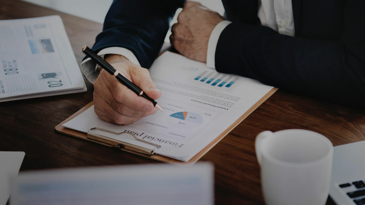 Business person reading a financial plan