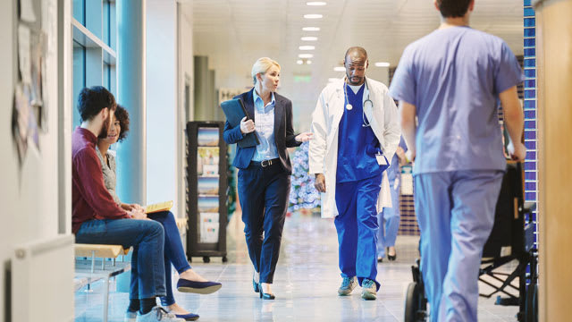 care-team-walking-down-hospital-hallway