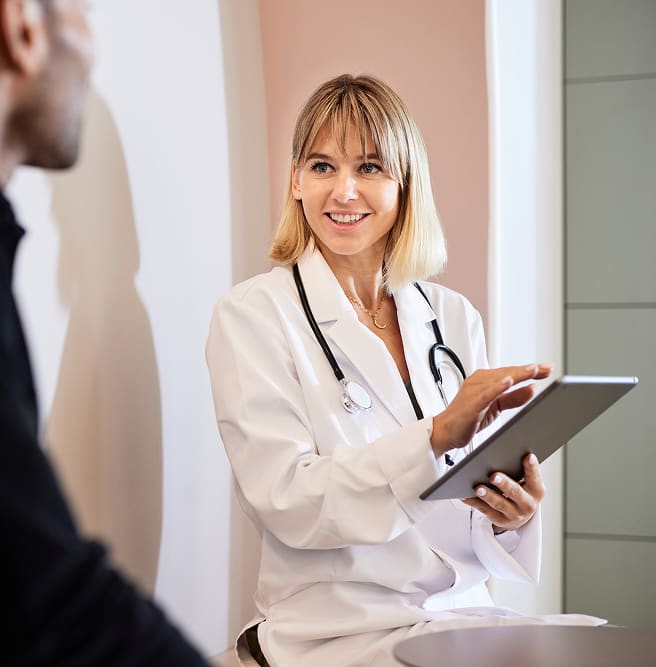 clinician-reviewing-files-on-iPad-with-patient