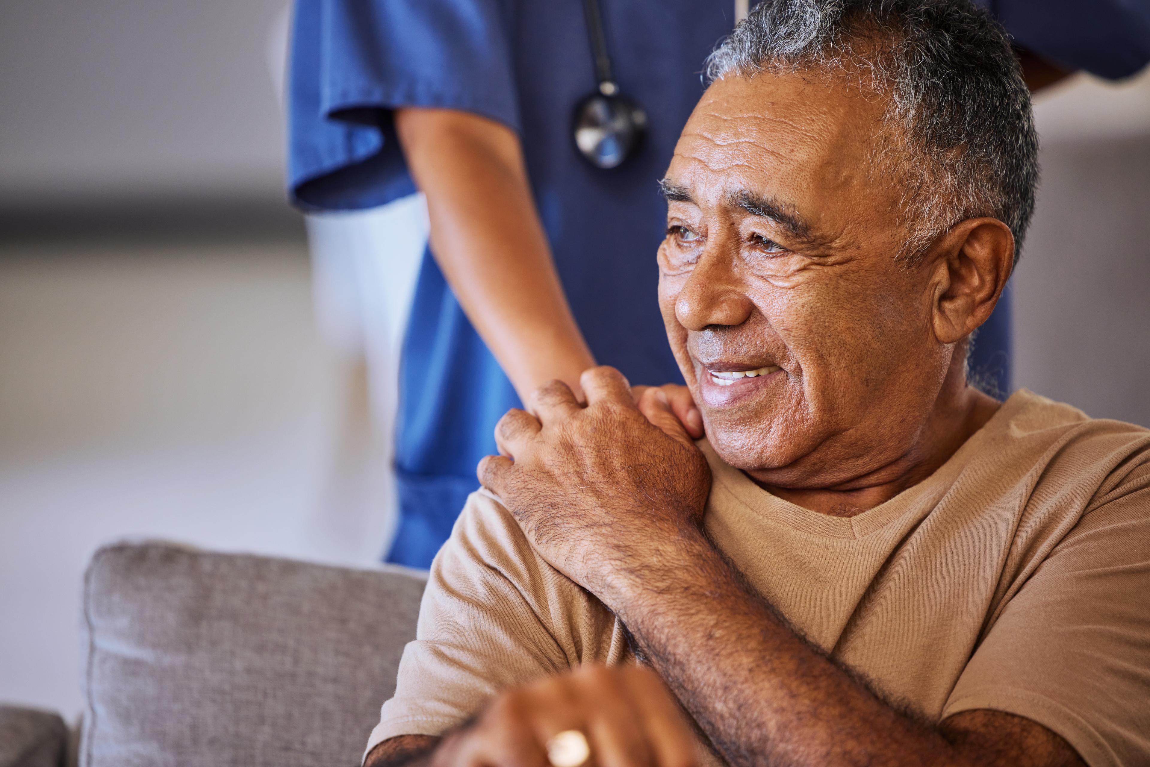 Patient with a doctor's hand on their shoulder