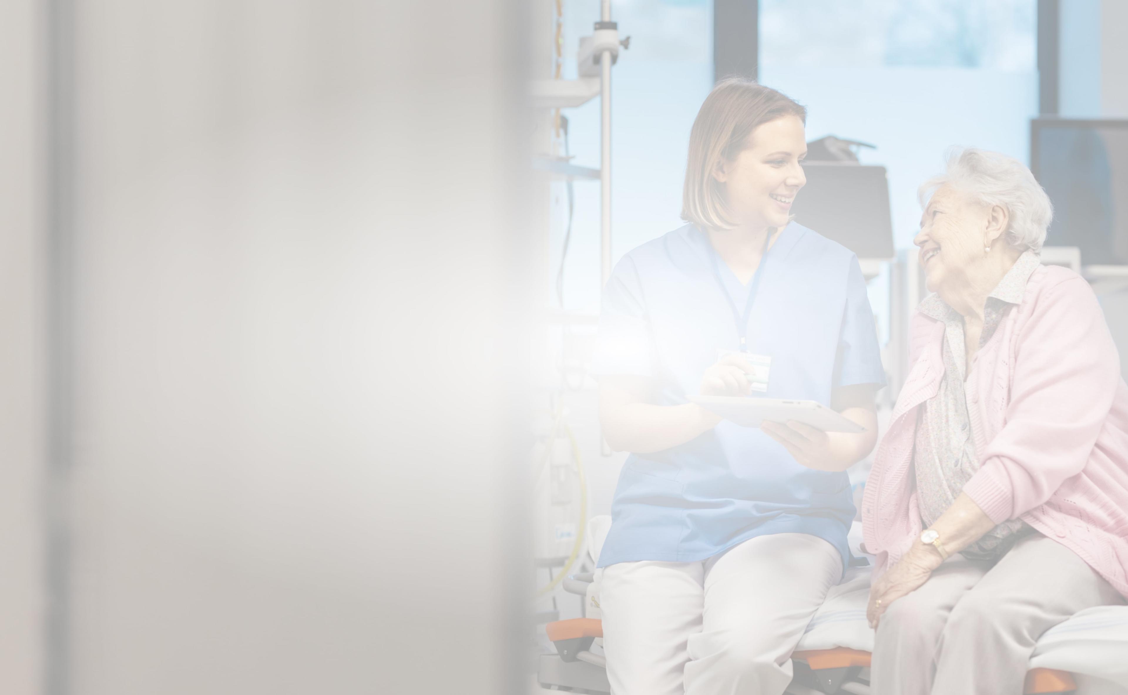 older woman talking to nurse