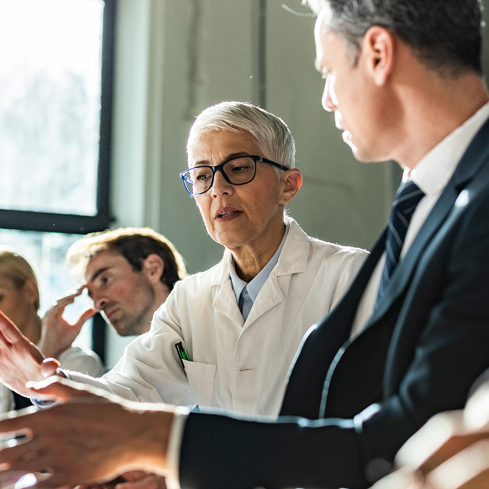 Doctors at a conference table discuss serious issues