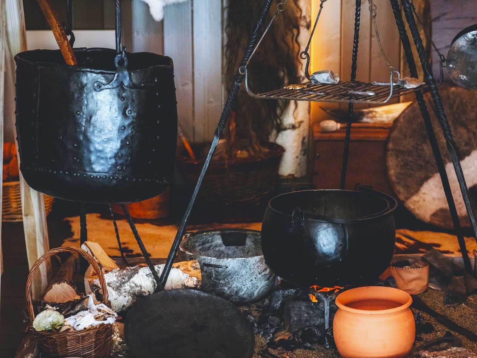 An indoor cooking spot with black pots and wooden blocks.