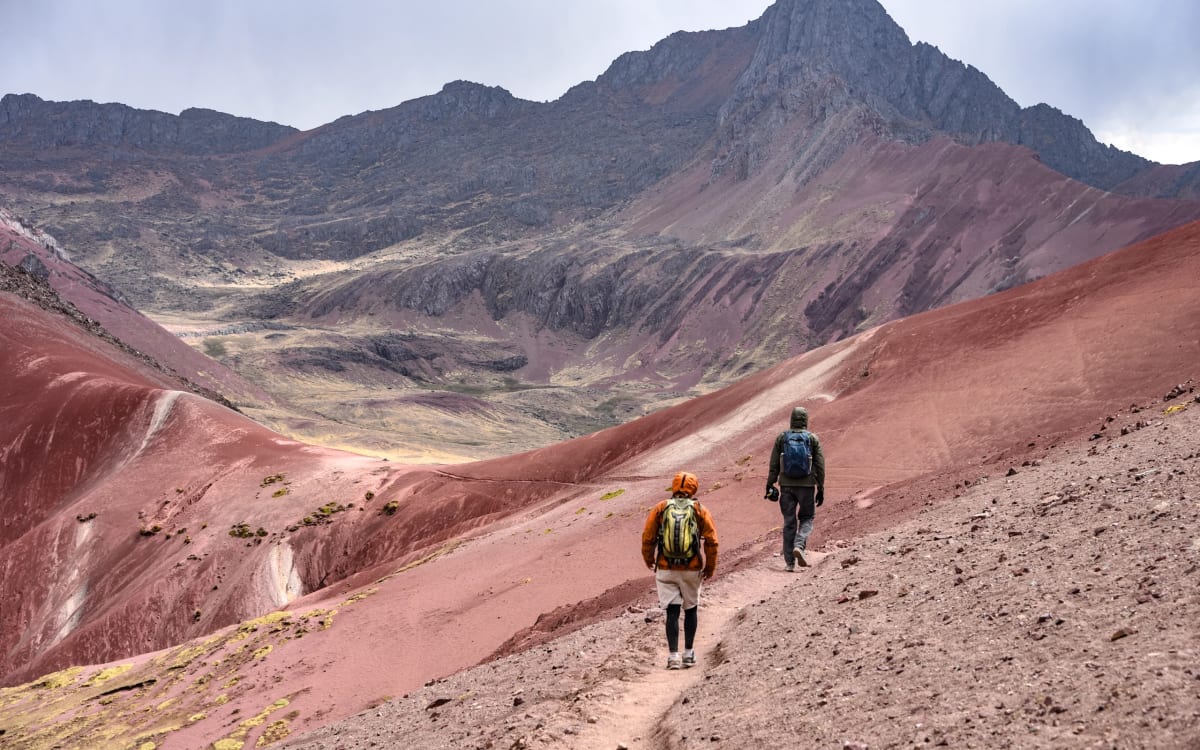 Hikers on the colored ridge of Rainbow Mountain