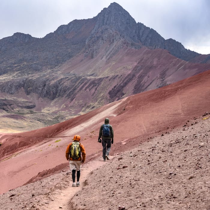 Hikers on the colored ridge of Rainbow Mountain