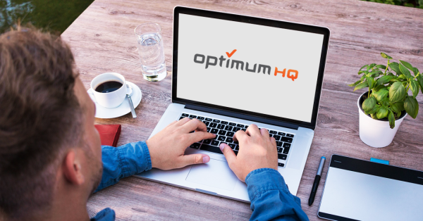 man with a computer with OptimumHQ logo on the screen