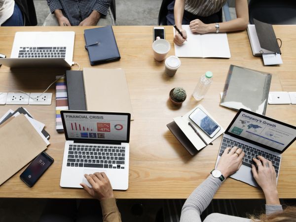 team members at a table with laptops