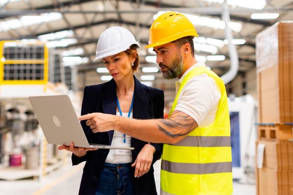 Manufacturing workers looking at laptop