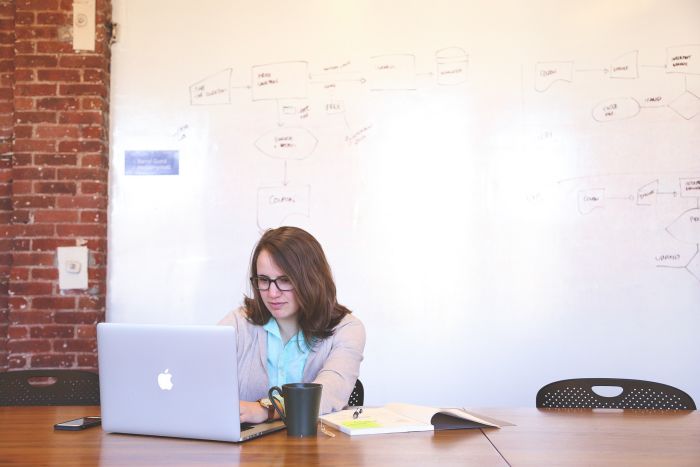 woman with laptop focused and working